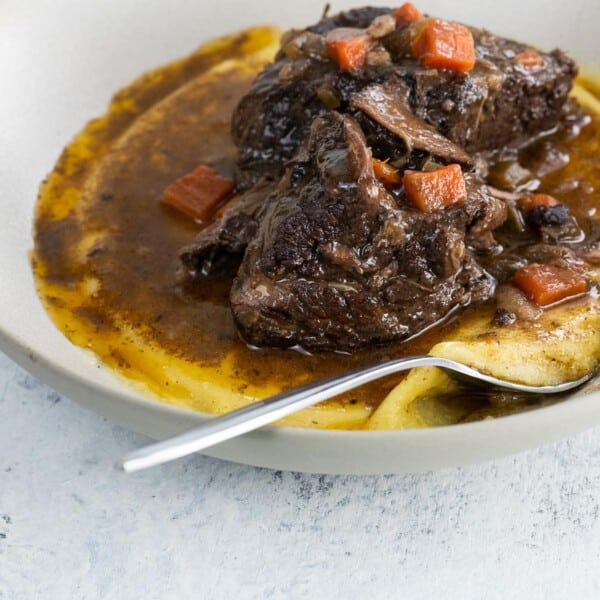 a bowl with braised beef short ribs and polenta