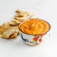 roasted red pepper hummus in a bowl with pita chips