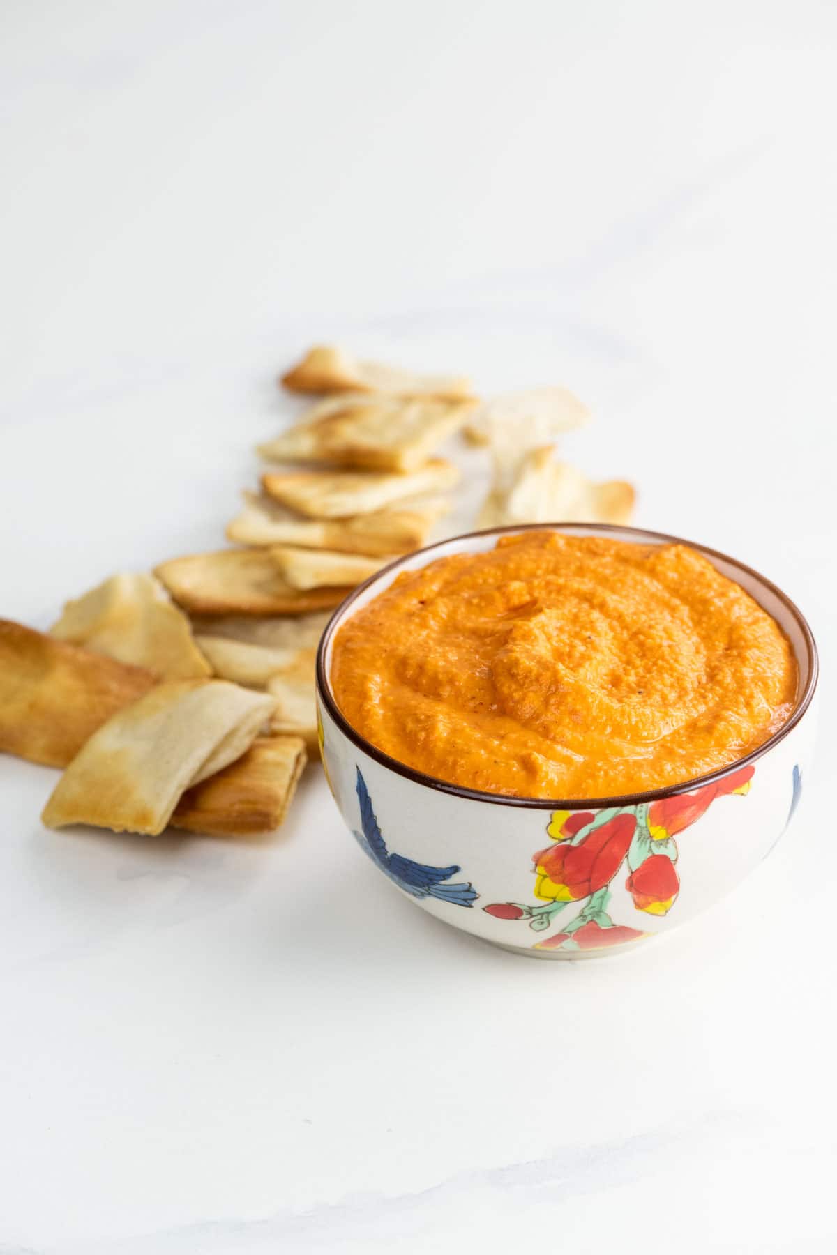 roasted red pepper hummus in a bowl with pita chips