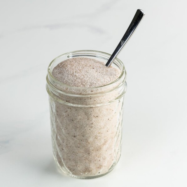 spiced sugar in a decorative jar with a small spoon