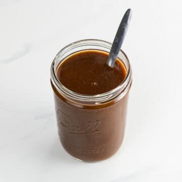 tex mex enchilada sauce in a jar with a spoon