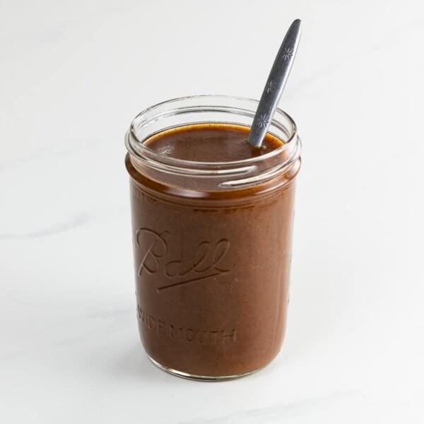 tex mex enchilada sauce in a jar with a spoon
