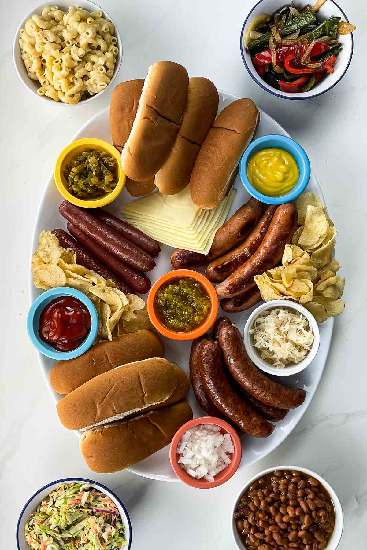 hot dog bar ingredients on bowls and on a platter