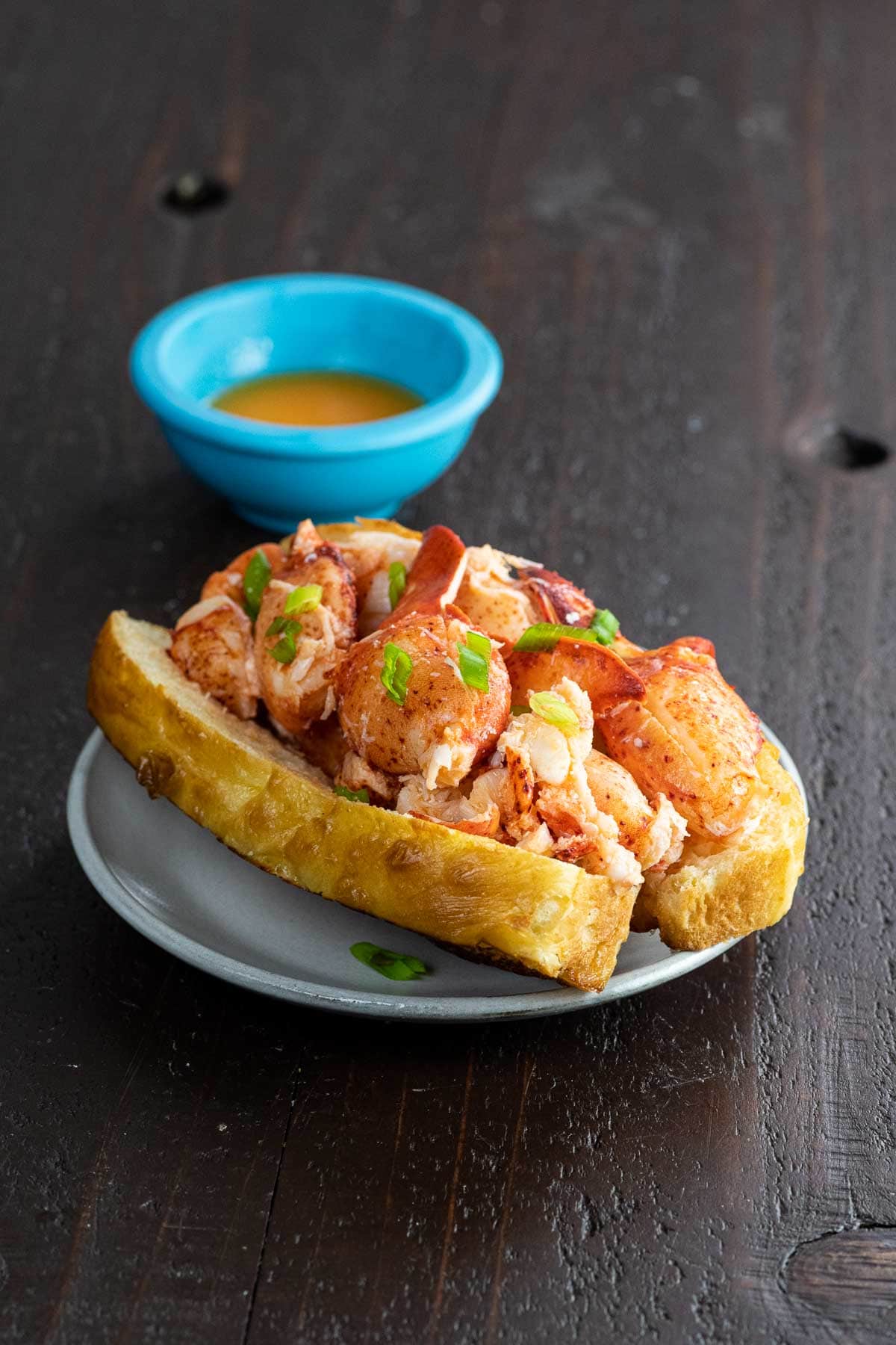 a connecticut style lobster roll in a new england style hot dog bun with lemon butter