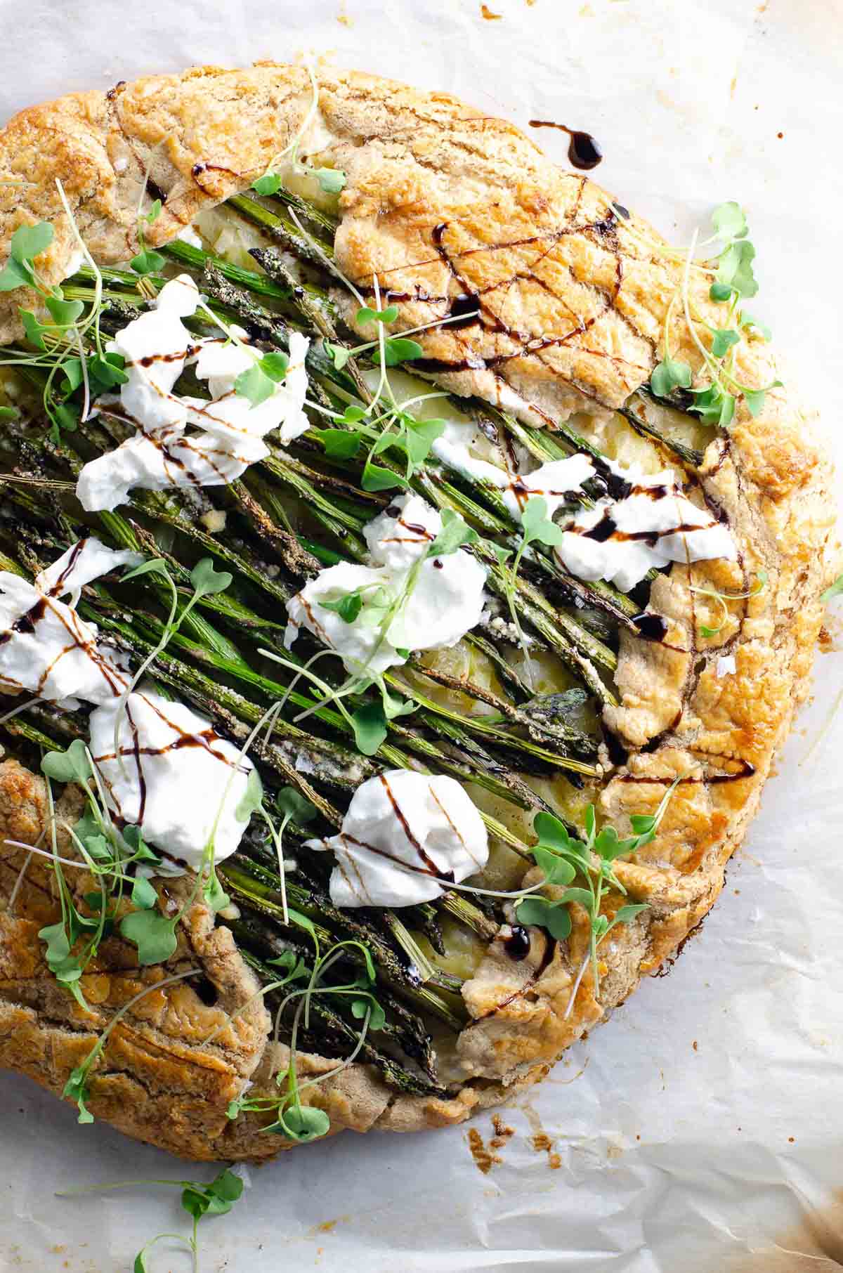 an asparagus galette with jammy leeks, ricotta, and burrata made with savory tart dough