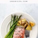sheet pan salmon and veggies on a plate with a fork