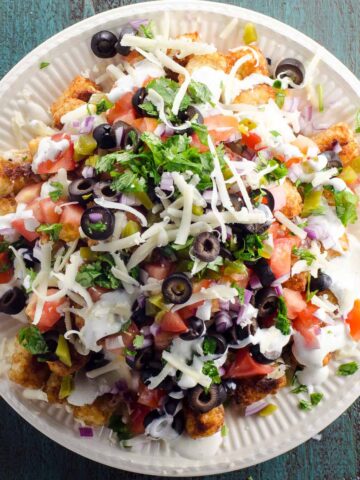 totchos (tater tot nachos) piled high on a plate