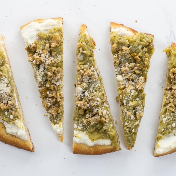 broccoli flatbread with ricotta and olives cut into wedges