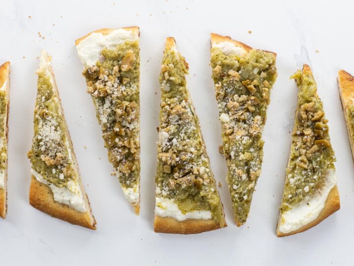 broccoli flatbread with ricotta and olives cut into wedges