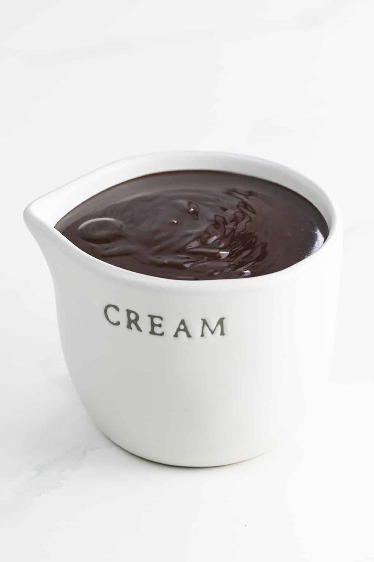 chocolate sauce for ice cream in a small pitcher