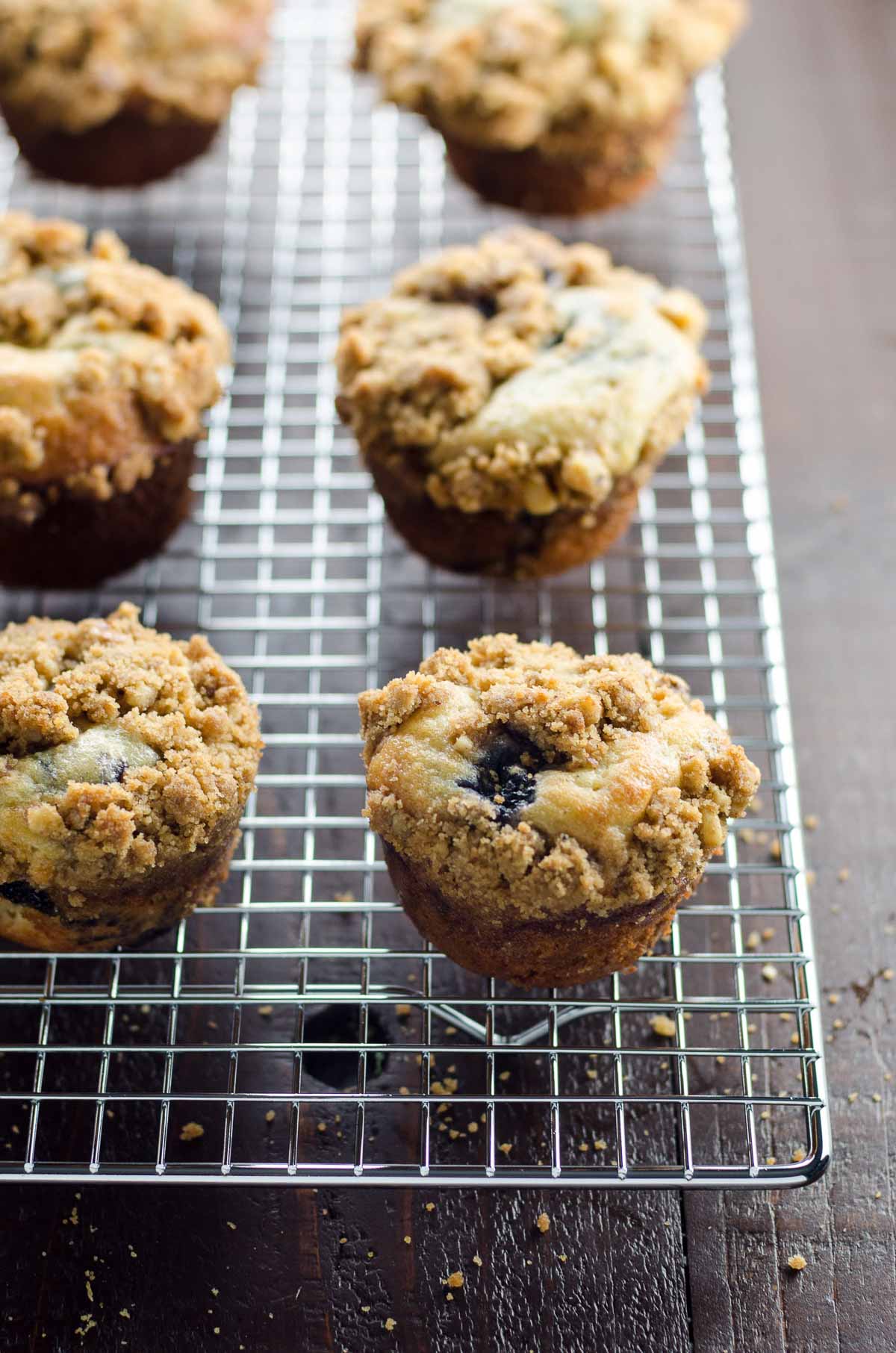 greek yogurt blueberry mufifins with streusel topping on a cooling rack