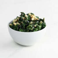 sautéed kale with garlic and parmesan in a white bowl