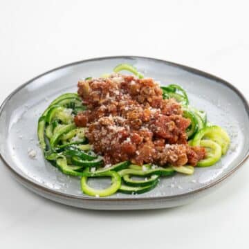zoodle spaghetti wtih turkey meat sauce on a plate