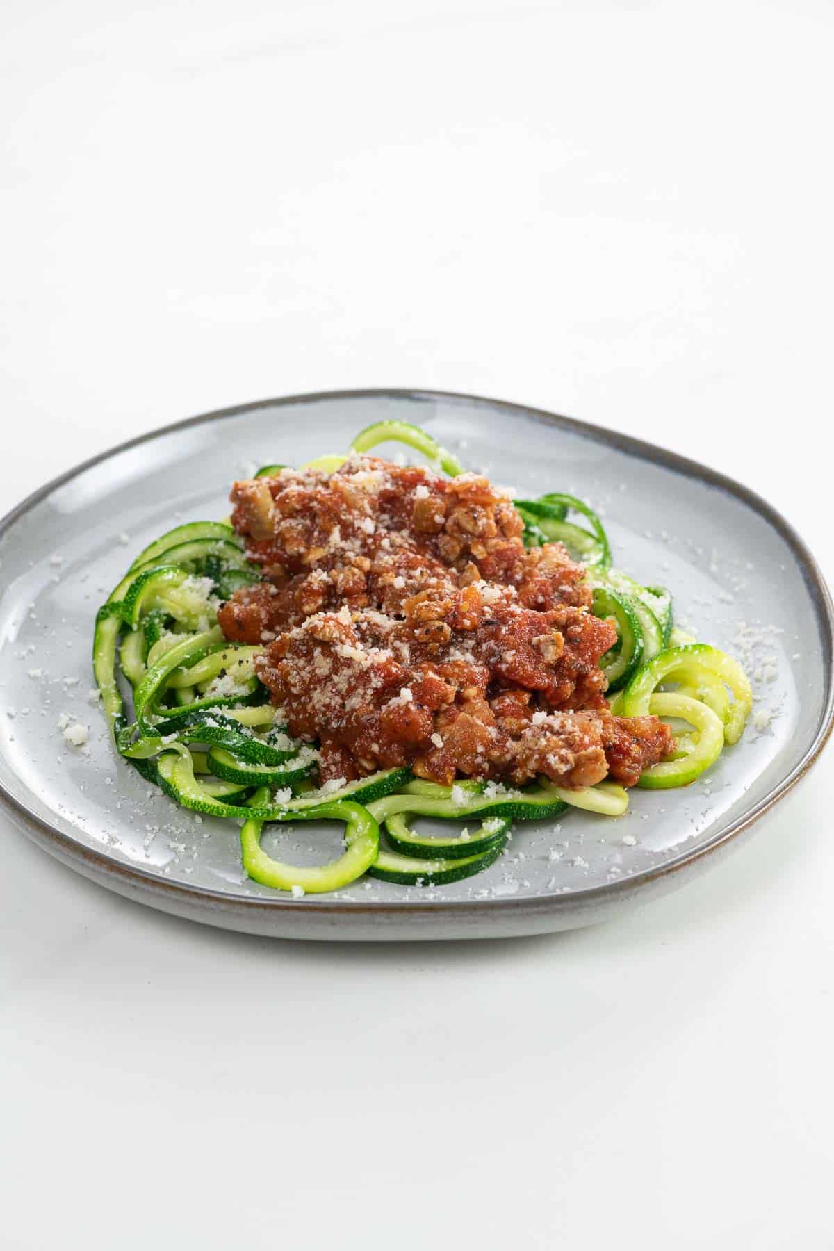 zoodle spaghetti wtih turkey meat sauce on a plate