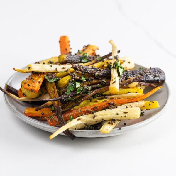 roasted rainbow carrots with cumin, mustard seed, and cilantro on a plate
