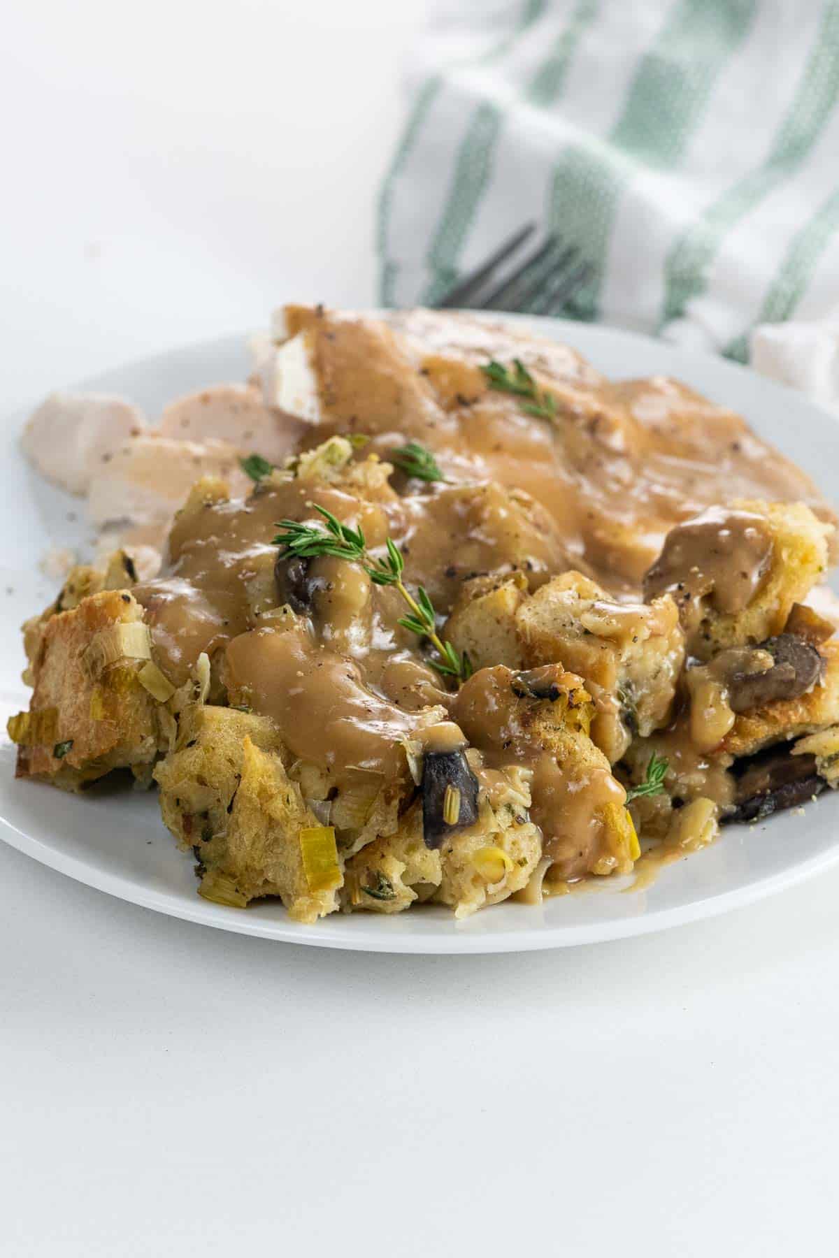 vegan mushroom stuffing with chestnuts on a plate with turkey and gravy