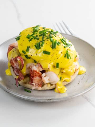 lobster benedict with immersion blender hollandaise on a small plate with a fork