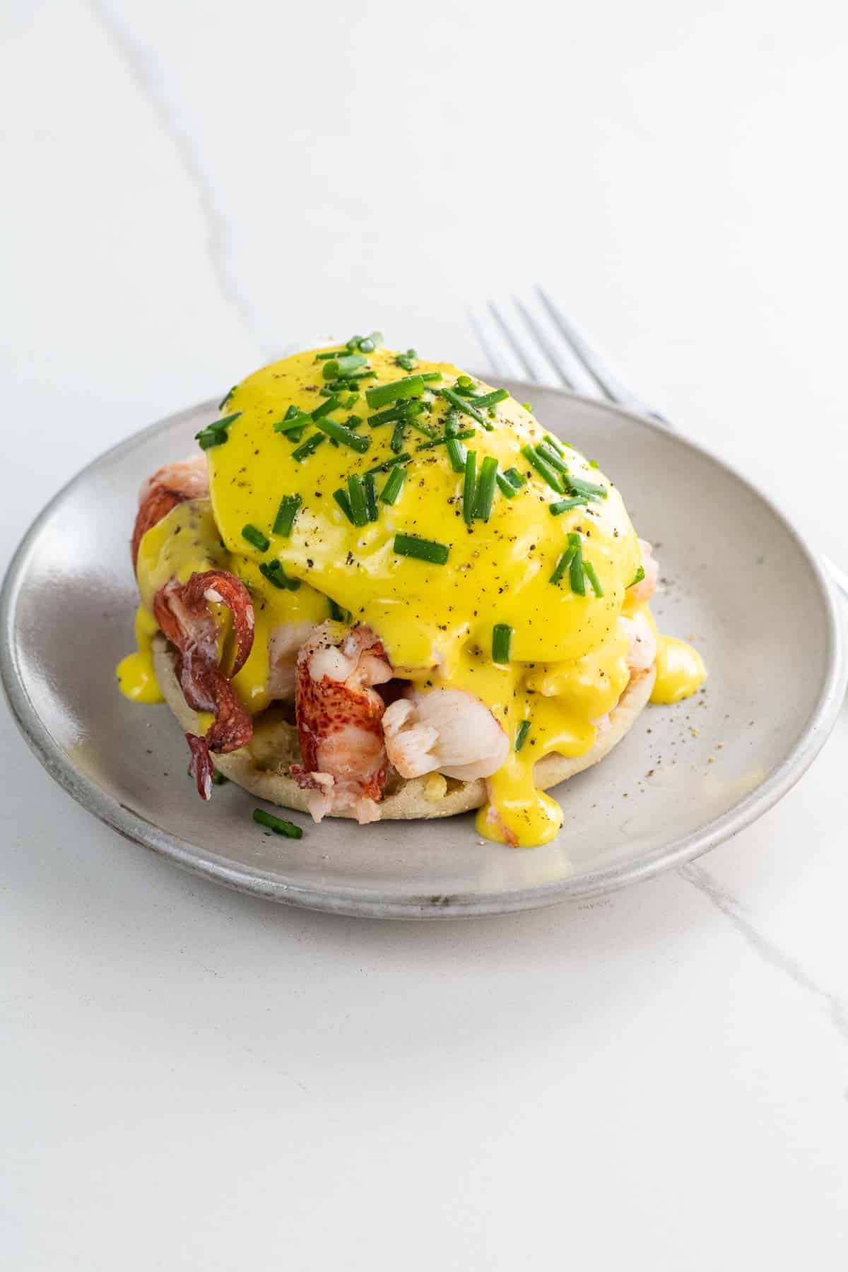 lobster benedict with immersion blender hollandaise on a small plate with a fork