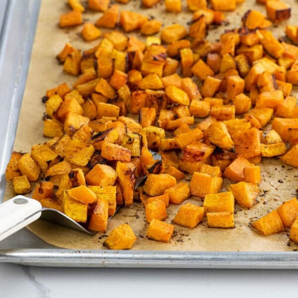 maple roasted butternut squash on a sheet pan with a spatula