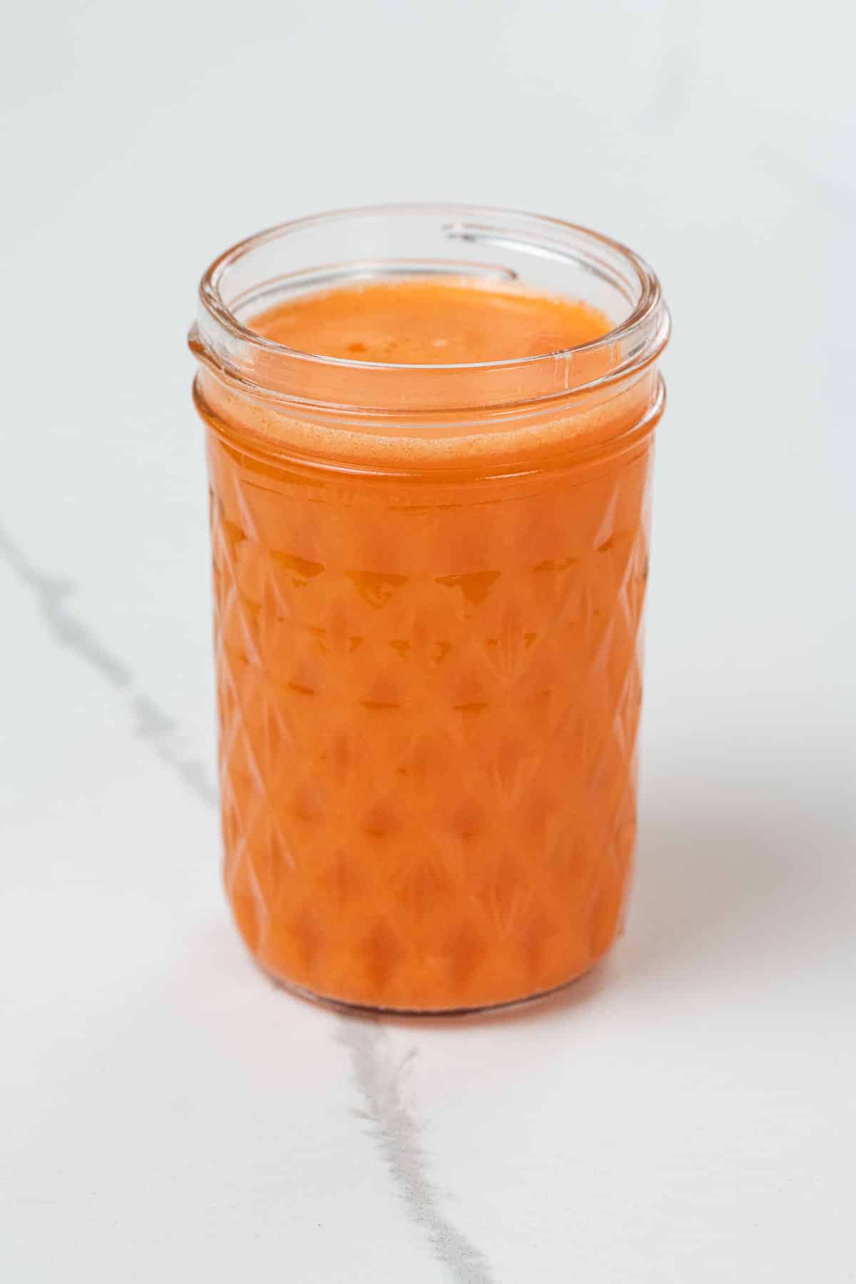 sweet potato, carrot, and orange juice in a small glass