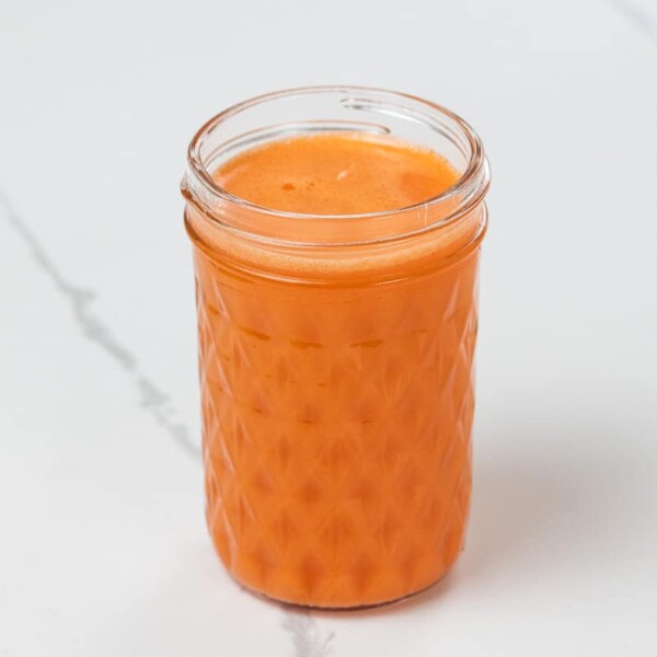 sweet potato, carrot, and orange juice in a small glass