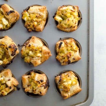 leek and feta puff pastry cup appetizers in a mini muffin tin