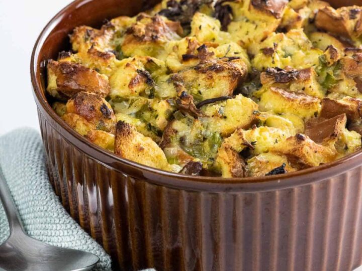 savory bread pudding with gruyere, chanterelles, and leeks in a souffle dish