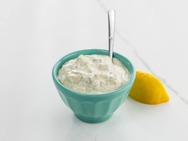 tartar sauce for crab cakes, fish, oysters, and more in a small bowl with a spoon and a lemon wedge