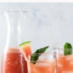 watermelon cucumber agua fresca in a pitcher and two glasses
