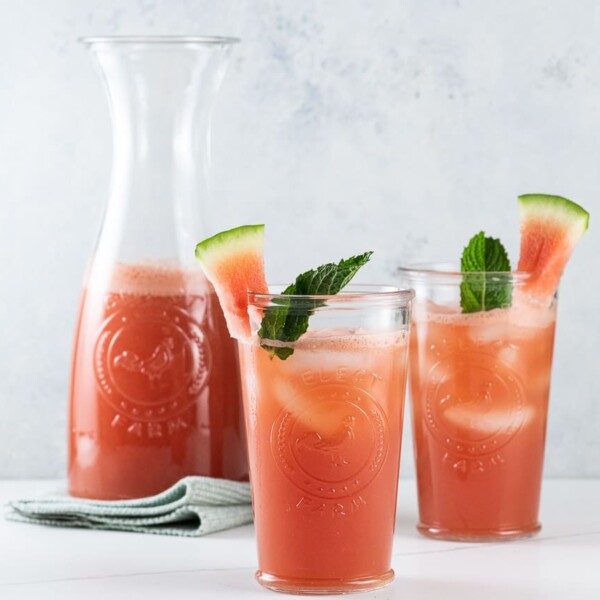 watermelon cucumber agua fresca in a pitcher and two glasses