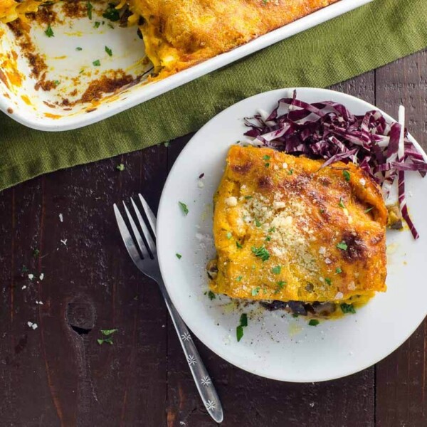 fall lasagna with kabocha squash bechamel, mushrooms, and radicchio on a plate with a fork