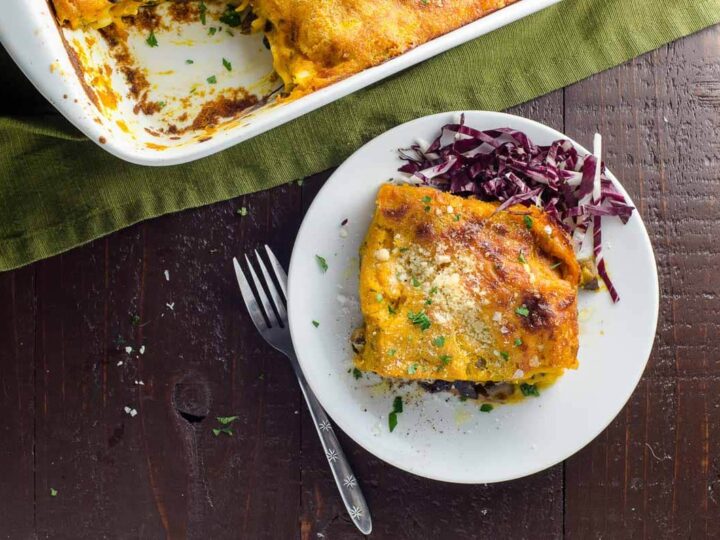 fall lasagna with kabocha squash bechamel, mushrooms, and radicchio on a plate with a fork