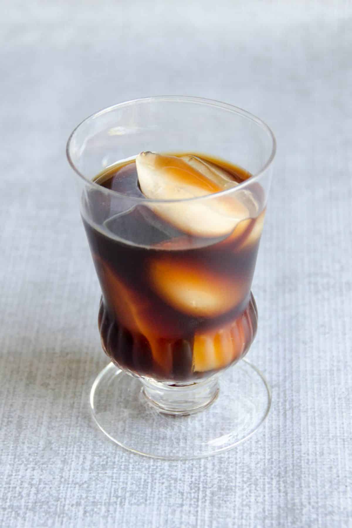 french press cold brew in a glass with ice