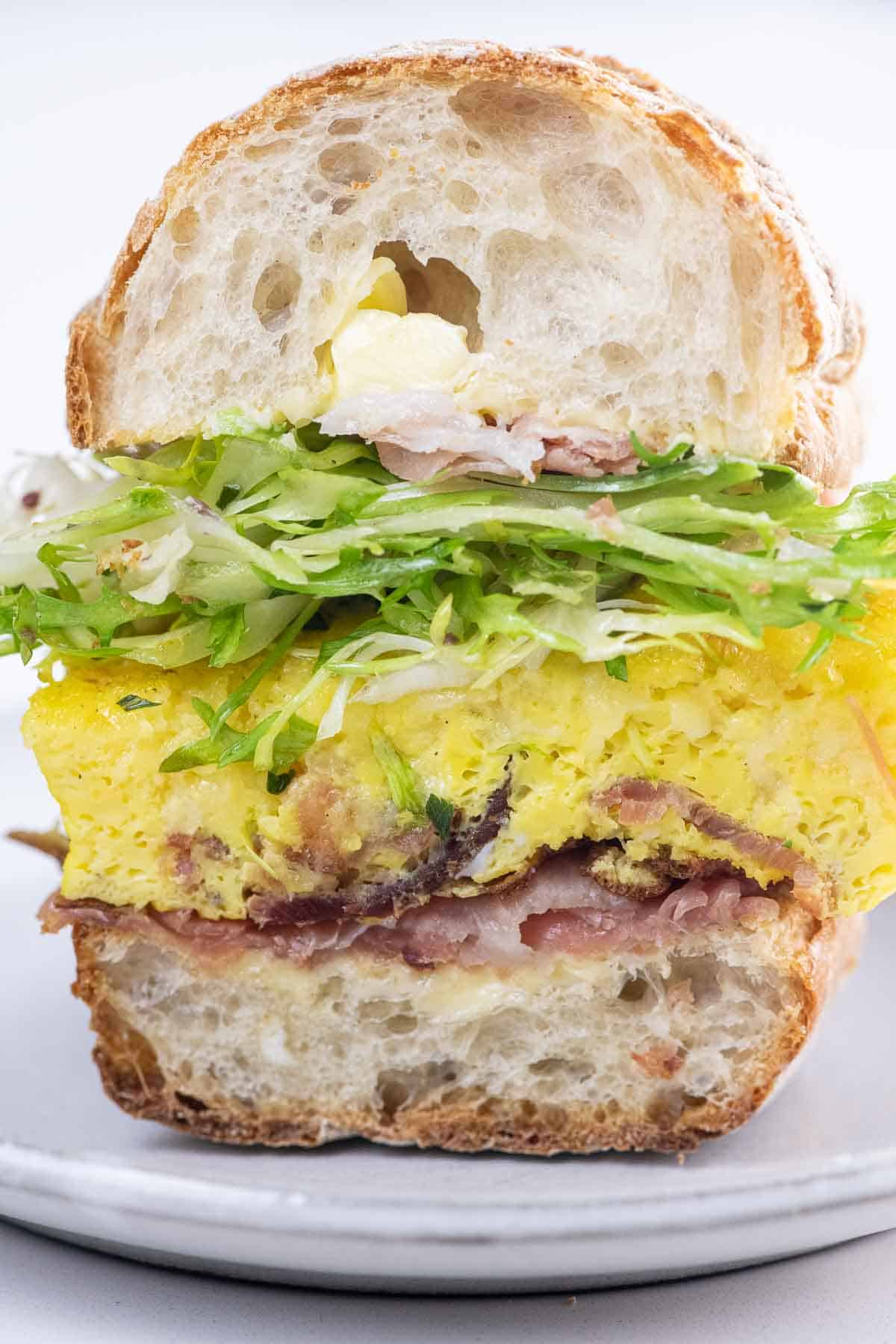 a scrambled egg sandwich on a toasted ciabatta roll