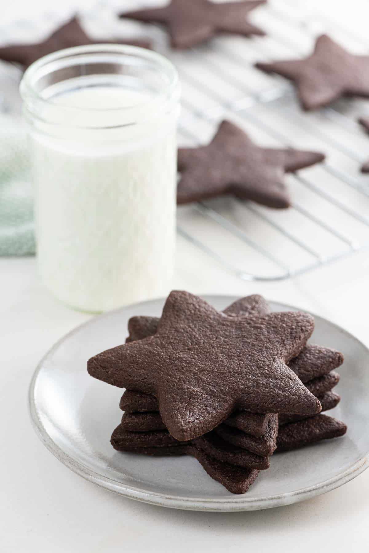 star-shaped chocolate sugar cookies and a glass of milk