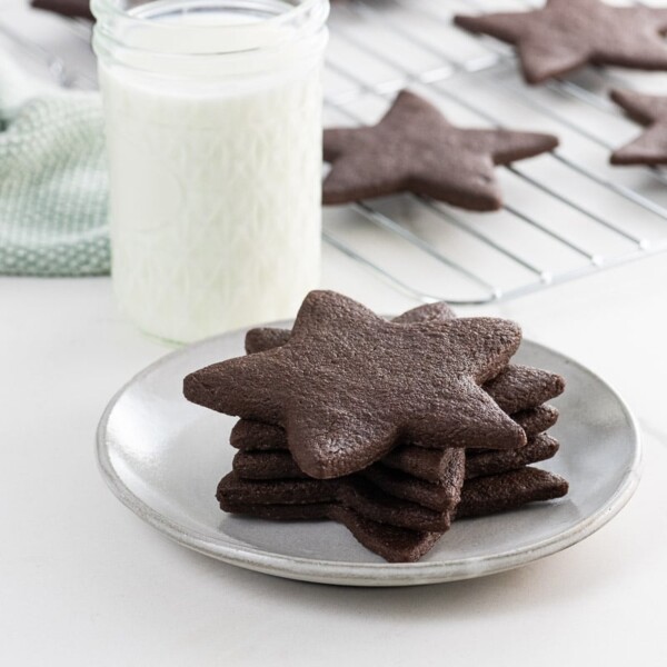 star-shaped chocolate sugar cookies and a glass of milk