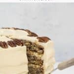 an old fashioned hummingbird cake on a cake stand with a slice being removed