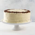 an old fashioned hummingbird cake on a cake stand