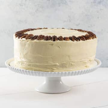 an old fashioned hummingbird cake on a cake stand