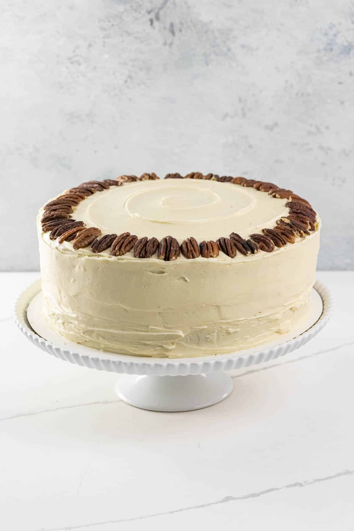 an old fashioned hummingbird cake on a cake stand