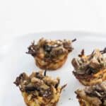 four potato nests filled with marsala mushrooms on a plate