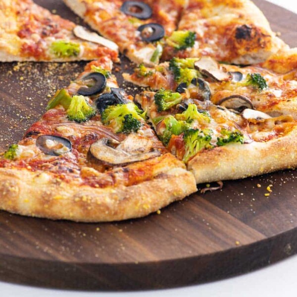 veggie supreme pizza slices on a cutting board