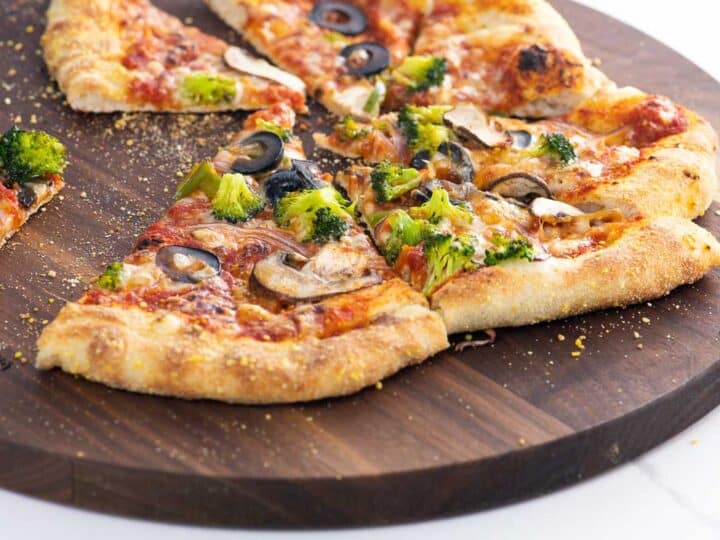 veggie supreme pizza slices on a cutting board