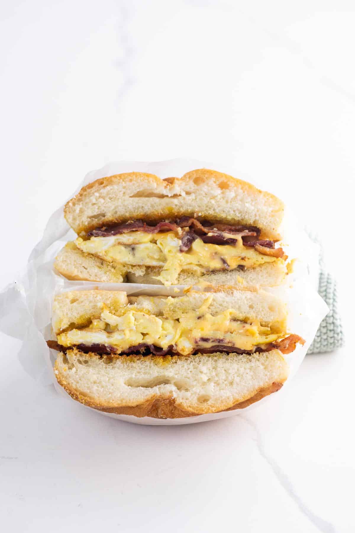 a bacon egg and cheese sandwich in deli paper
