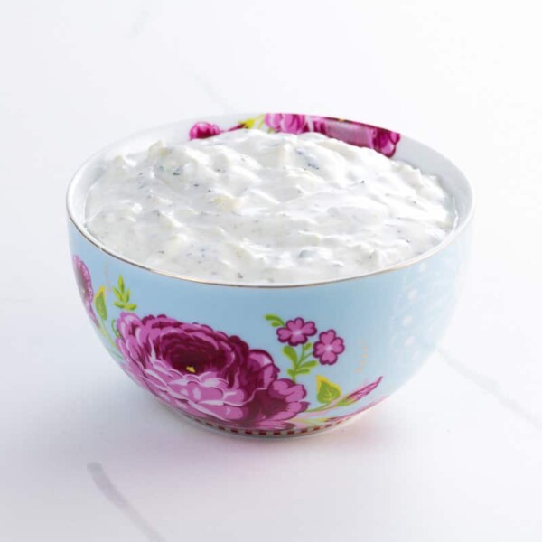 a decorative bowl containing an easy raita recipe