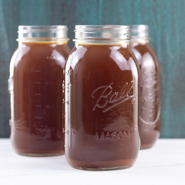 three quarts of lobster stock in mason jars