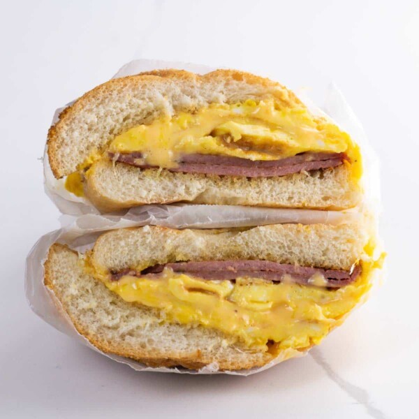 a pork roll egg and cheese sandwich on a kaiser roll wrapped in deli paper