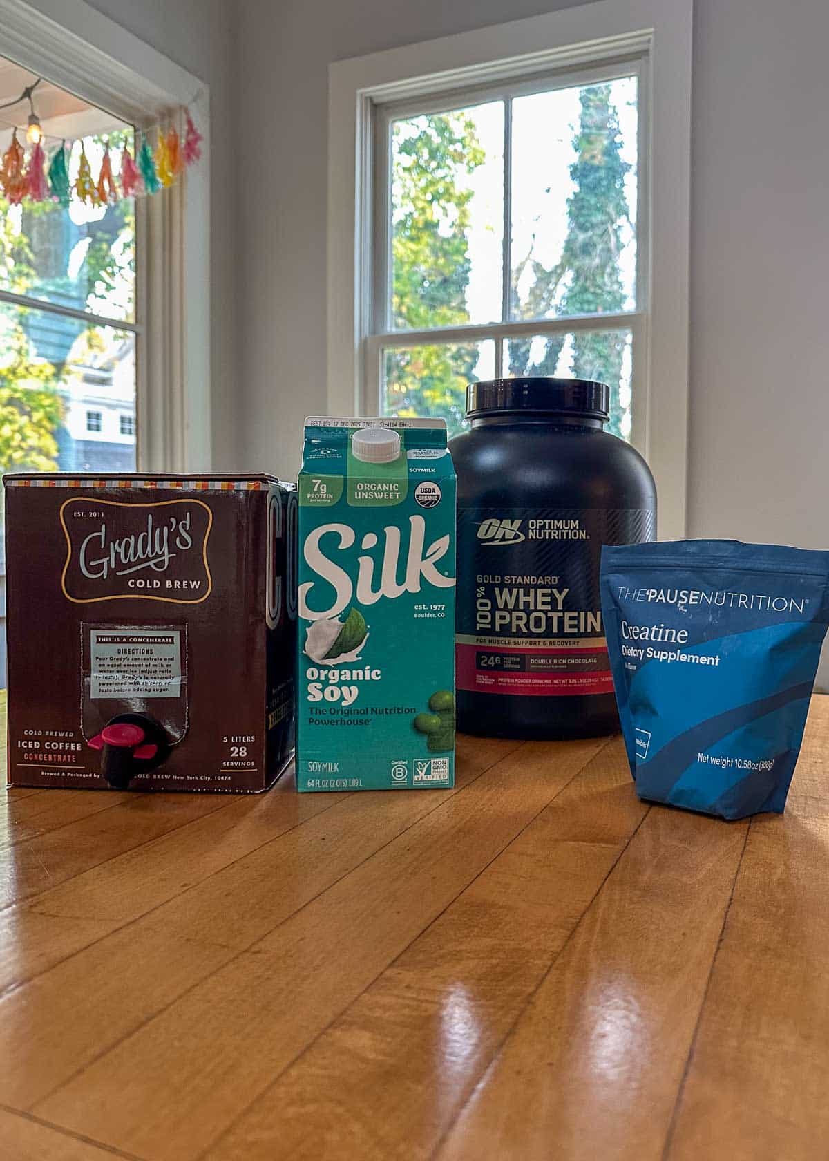 cold brew, soy milk protein powder, and creatine on a table