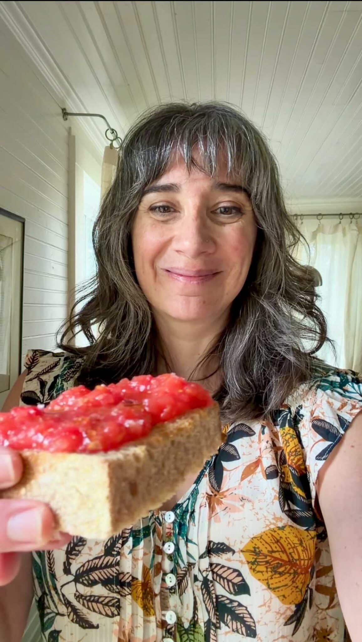 Carolyn Gratzer Cope holding a piece of pan con tomate