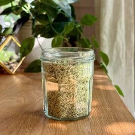 a jar of basil salt on a table